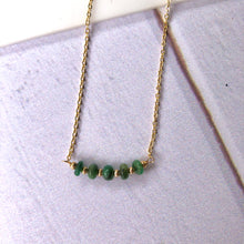 Cargar imagen en el visor de la galería, Cinco piedras de jade esmeralda de 3mm cada una, colocadas en el centro de una cadena bañada en oro. Esmeralda es la piedra del mes de mayo. Largo: 41cm con extensión ajustable de 5cm.